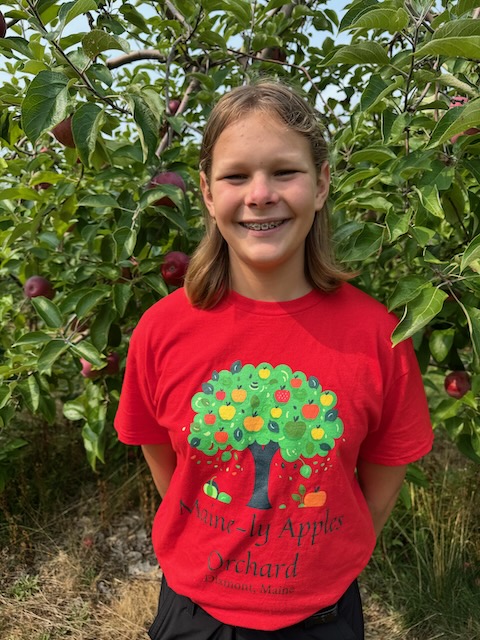 boy wearing a Maine-ly Apples t-shirt